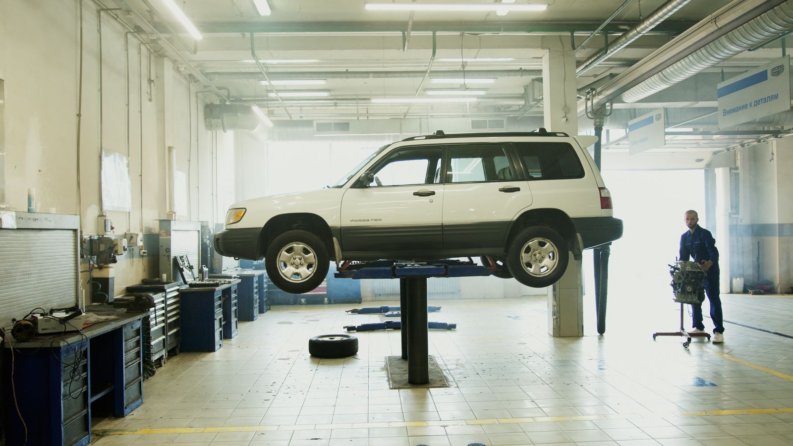 Car raised on a lift in the R&M Mechanics workshop