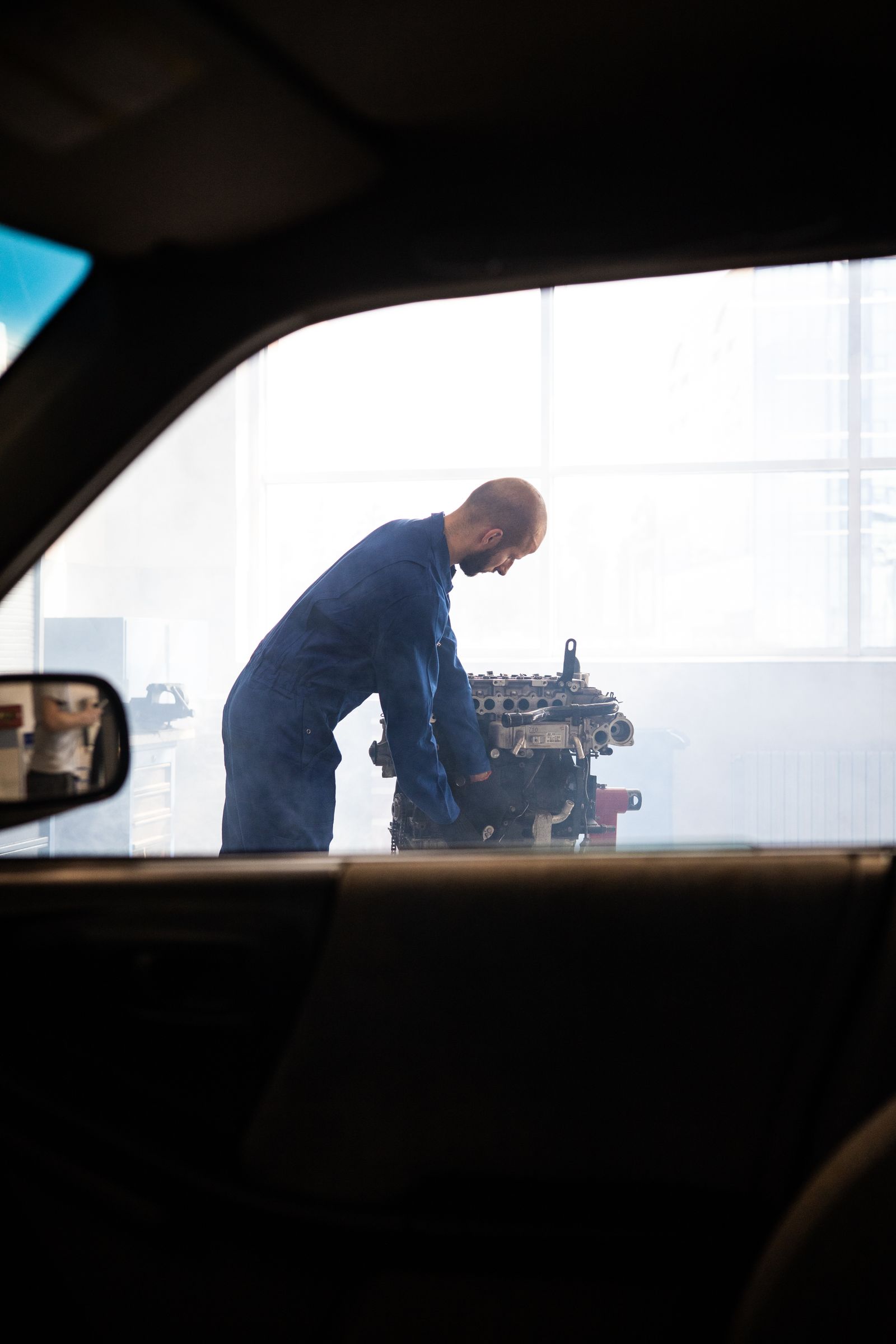 Mechanic working on a car engine in the workshop